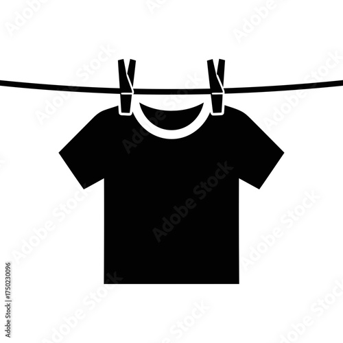 Black tshirt hanging on a clothesline with clothespins