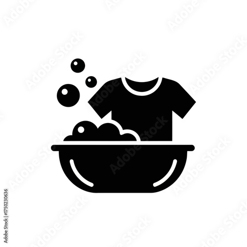 Black icon of a tshirt being washed in a basin with soap bubbles and water
