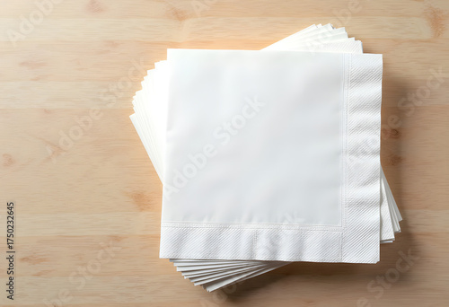 Stack of paper napkins mockup on the light wood background, top view