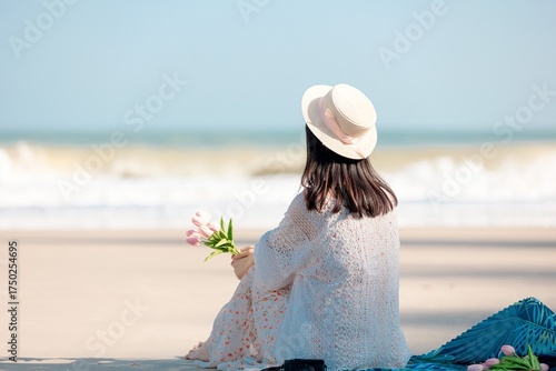 Woman in Lace Dress and Hat on Sandy Beach Overlooking the Ocean Waves on Bright Sunny Day with Clear Blue Sky