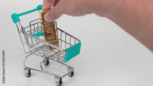 Gold bars in a small shopping cart symbolizing wealth, investment, and financial growth on a clean white background.