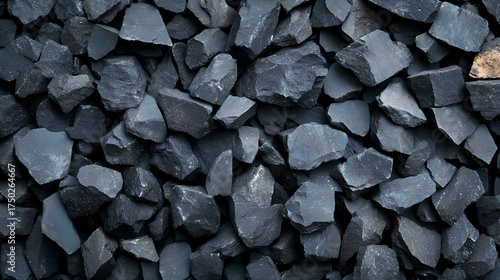 Raw molybdenum ore crystals on black shale with metallic reflections,showcasing strategic mineral resources and clean energy materials for industrial use.