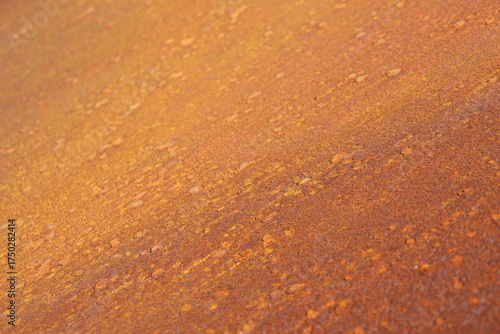 Rusty metal background in brown, red and orange colors. Rusty métal with particles and texture. Grainy rust and construction industry. Canvas and pattern in metallic texture.