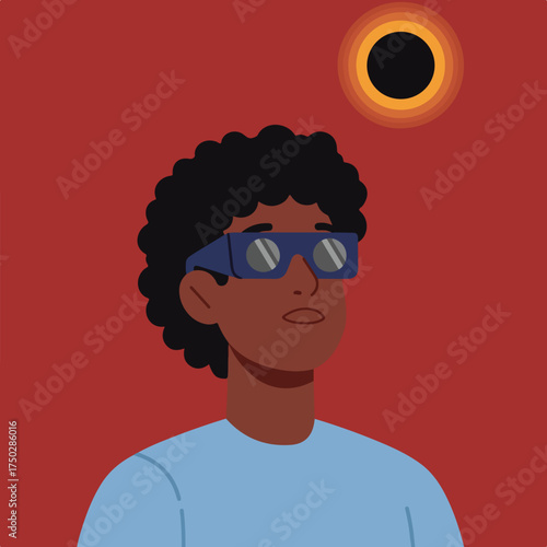Person wearing eclipse glasses watches a solar eclipse against a red sky