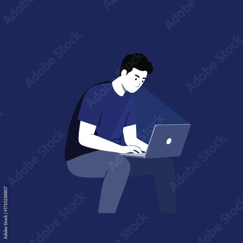 Young man intensely focused on his laptop screen in a dark, blue environment