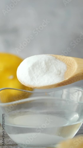 baking soda powder pouring in a bowl of water 