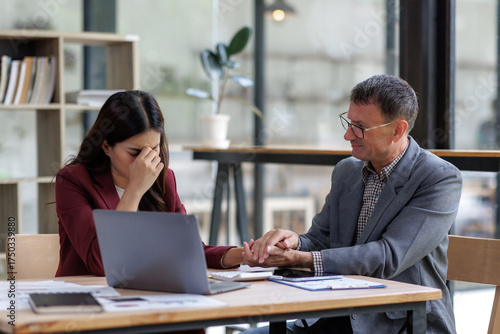 Obraz na płótnie Colleague providing emotional support to distressed business woman
