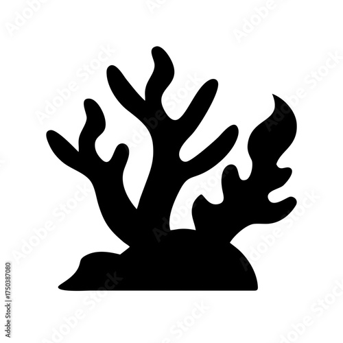 A close up of a black cat with bright green eyes looking directly at the camera with a soft focus background and a slight tilt of its head