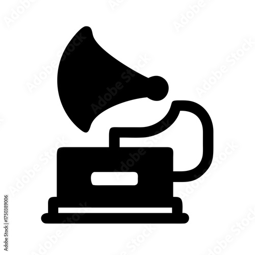 A close up of a black cat s face with bright green eyes looking directly at the camera in a dark setting with soft lighting highlighting its fur and whiskers