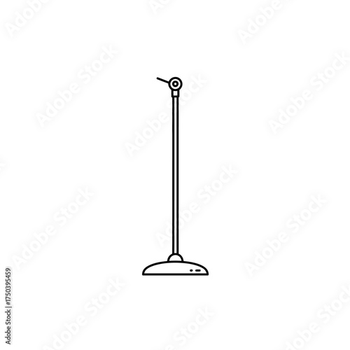 Microphone standing tall on stage ready for performance in empty auditorium, creating sense of anticipation and focus.