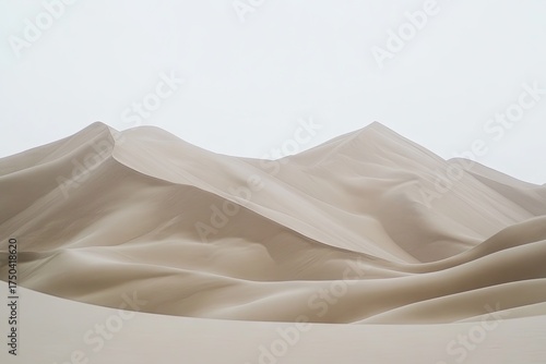 Fototapeta Naklejka Na Ścianę i Meble -  Pale sand dunes rise gently against a bright white sky