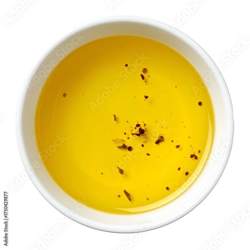 Overhead shot of a white bowl filled with golden, speckled oil
