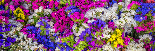 Panorama of bunches of colourful flowers making an abstract pattern image