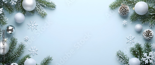 Christmas background with white and silver decorations on a light blue surface, a flat lay composition, top view.