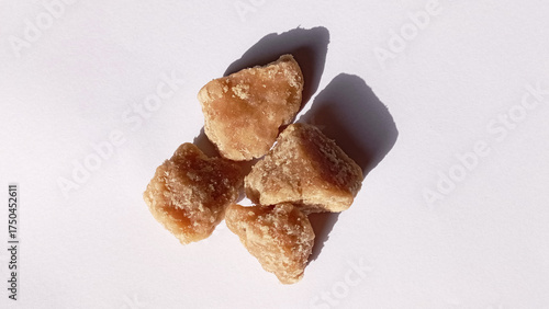 Jaggery brown sugar cubes. Sugar can jaggery on isolated white background