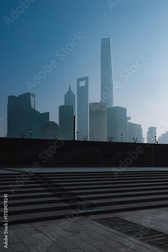 Cityscape with modern skyscrapers, including some of Shanghai’s most recognizable buildings, rises in the background, slightly softened by a light haze.