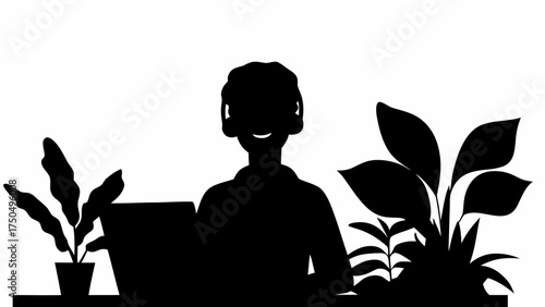Person smiling while working at a laptop among plants, creating a relaxed and productive atmosphere