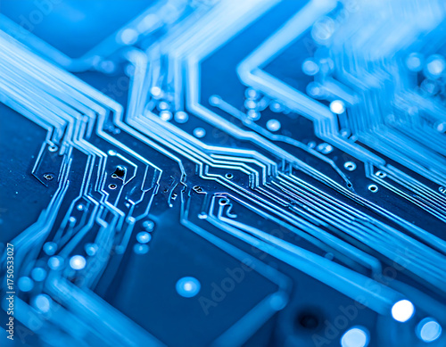 Close-up of a blue circuit board showcasing intricate pathways and components, emphasizing technology and connectivity.