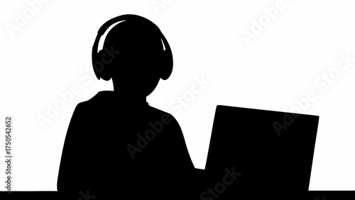 Focused individual wearing headphones works diligently on a laptop, symbolizing modern productivity and remote work