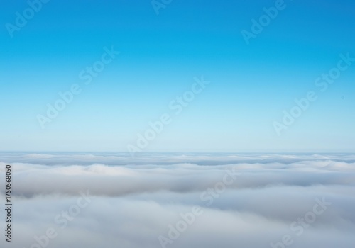 Dense morning fog slowly dissipates, revealing a serene, vibrant blue sky above. A peaceful, cool atmosphere with a soft, ethereal glow ,open ,weather ,atmospheric