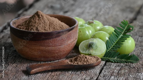 Fresh Amla (Indian gooseberry, Phyllanthus emblica) fruits with leaf on wooden background. herbal medicine plant