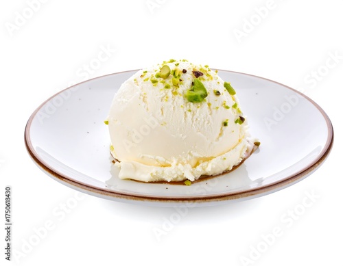 Creamy vanilla ice cream scoop topped with pistachios on a plate