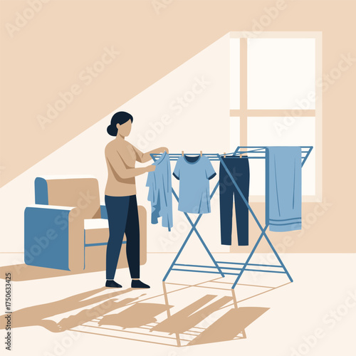 A young woman hangs clean clothes on a drying rack at home, illustrating laundry care and household chores.