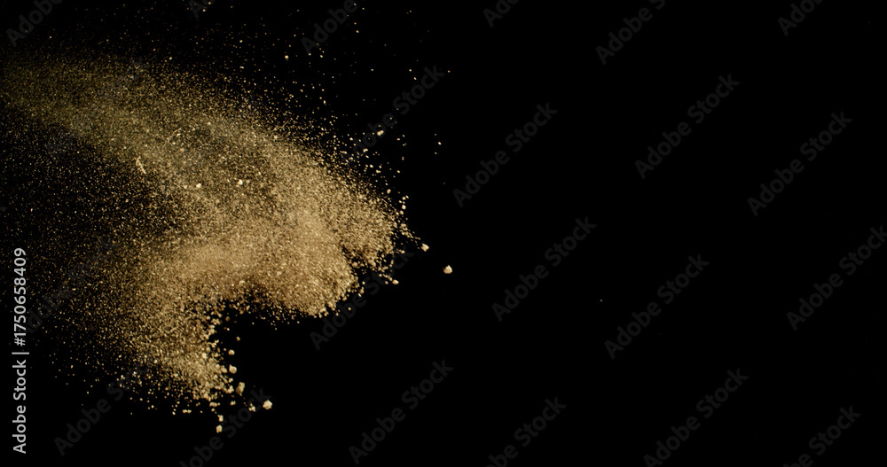 Fototapeta premium Fine beige cosmetic powder cloud suspended in air, isolated on black background. Elegant abstract motion concept captured in studio light. Makeup explosion and beauty design.