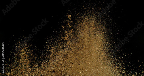 Detailed wave of airborne clay dust swirling in chaotic motion, captured in freeze  motion. Dramatic natural explosion of earthy particles on black background.