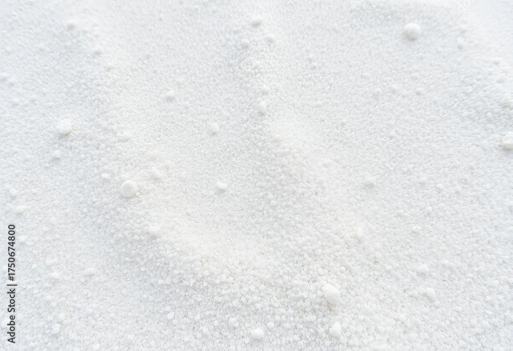 Fototapeta premium Fine, grainy white sand texture; close-up view showing subtle undulations, pattern, light
