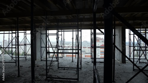 Construction scaffolding inside unfinished concrete building structure