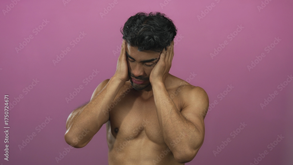 Fototapeta premium Hispanic man with bare chest presses temples with closed eyes in studio; tension discomfort fatigue.