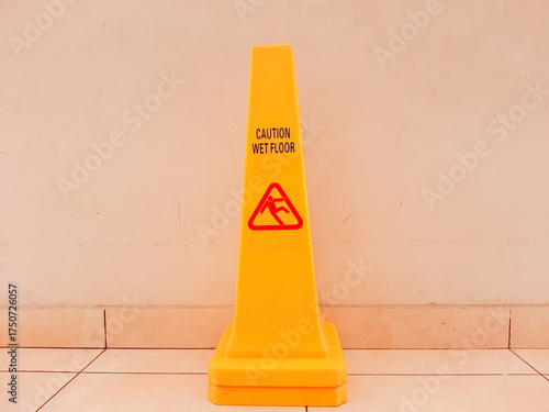 yellow sign that says wet floor or slippery floor
