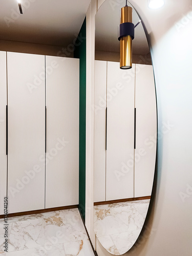 Beautiful modern hallway interior with a large mirror. Vertical photo.