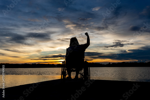 disabled woman in wheelchair watching sunset alone finding hope