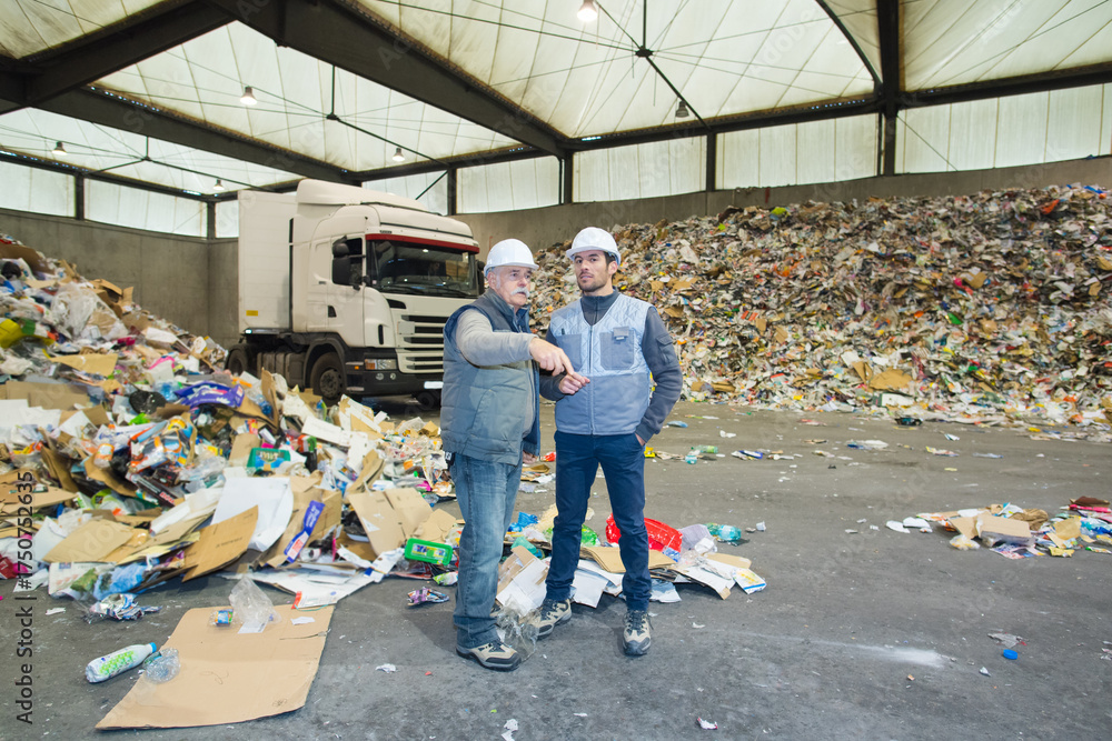 Fototapeta premium worker pointing at recycling pile