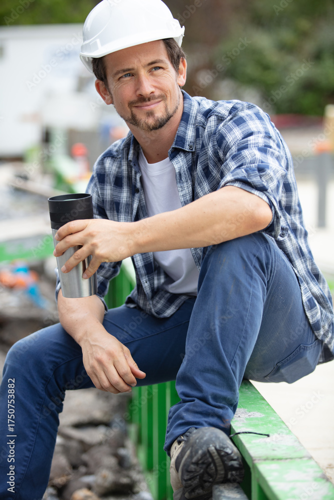 Fototapeta premium young handsome builder during coffee break