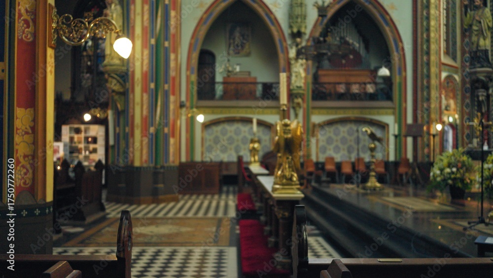 Fototapeta premium Interior of a vibrant, colorful catholic church with defocused, blurred architectural features and intricate decorations visible indoors.
