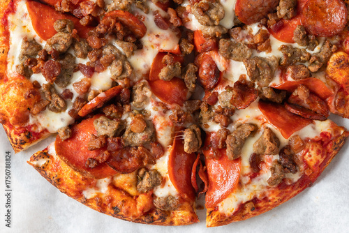 Meat lovers pizza loaded with pepperoni, sausage, bacon, and melted cheese.