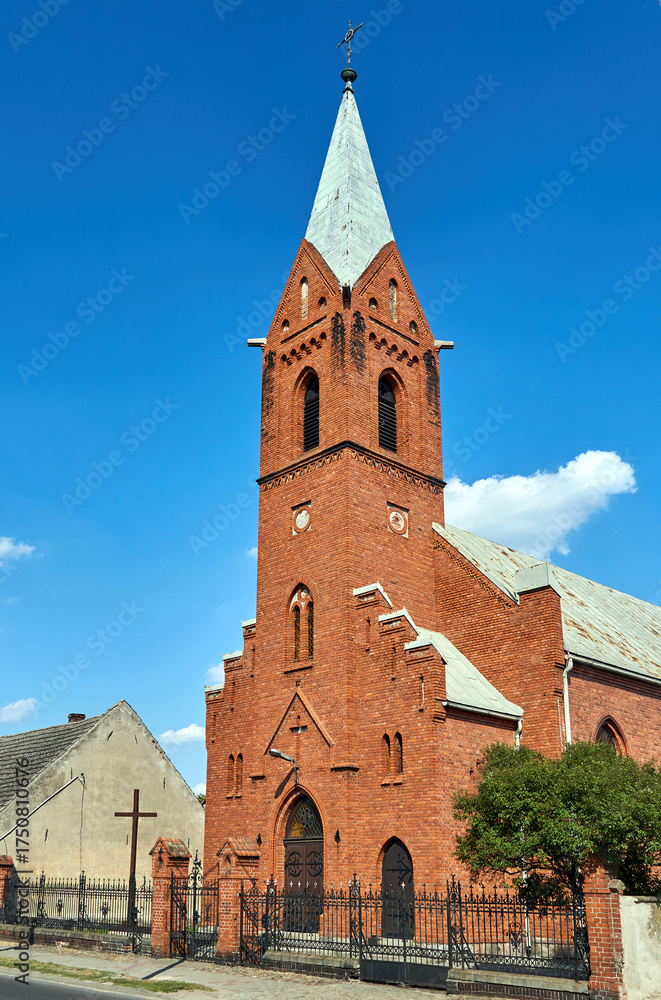 Fototapeta premium Neo-Gothic, historic brick parish church with bell tower 