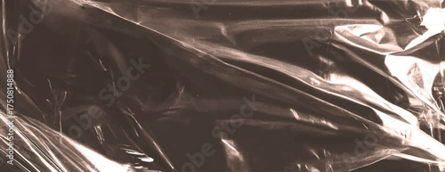 Brown background vector.A sepia-toned background with a glossy, crinkled texture. The background features sepia hues, creating a vintage, reflective style. Plastic foil wrap texture background.