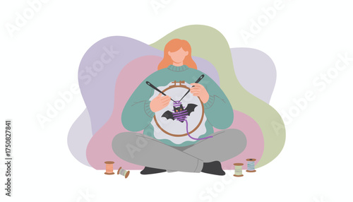 Woman embroidering a bat design engaged in a creative and relaxing hobby at home