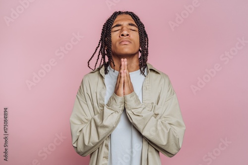 Fotografie portrait of young man is seen with a prayerful pose, conveying a sense of hopefu
