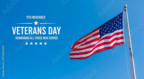 Veterans Day observance with an American flag proudly waving against a clear blue sky, symbolizing honor and gratitude for all who served the nation