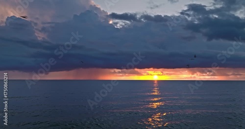 Cloudy sunbeams over sea at sunset in Poland.