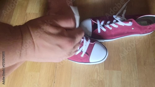 sport shoe my hands are tying white laces Cross and Pull Tight knot in red tennis running morning health tighten match tennis Active Lifestyle