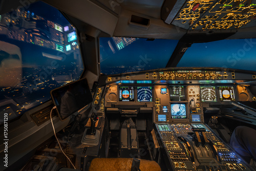 Foto Night cockpit view of modern commercial airplane above city lights