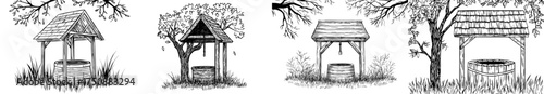A traditional well with a thatched roof is silhouetted amidst trees and grass