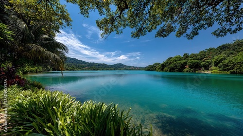 Beautiful nature landscape of a blue lake reflecting the cloudy sky and majestic mountains