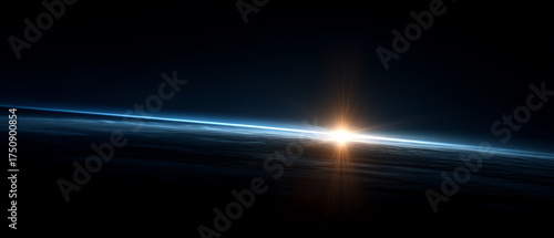 Sunrise over Earth's horizon seen from space, showing the thin blue atmosphere layer and the glowing sun emerging beyond the planet's curve against a dark cosmic background
